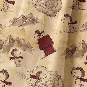 May include: A fabric pattern featuring a repeating illustration of Snoopy wearing an aviator cap and scarf. The design includes Snoopy flying on a red doghouse, mountains, and clouds against a beige, aged-paper background with brown ink lines.