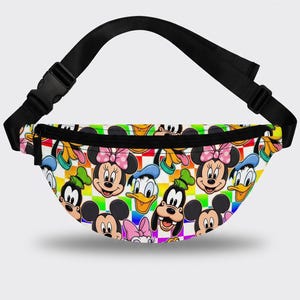 May include: A fanny pack featuring a colorful checkerboard background with a repeating pattern of cartoon character faces including Mickey Mouse, Minnie Mouse, Donald Duck, and Goofy. The bag has a black adjustable strap with a plastic buckle.