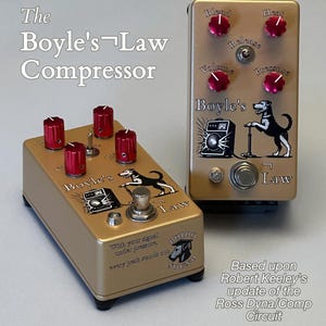 May include: Two gold-coloured guitar compressor pedals labelled The Boyle's Law Compressor. Each features four red knobs, a toggle switch, a footswitch, and a graphic of a dog with a pump. Text includes With your signal under pressure, every peak stands out.