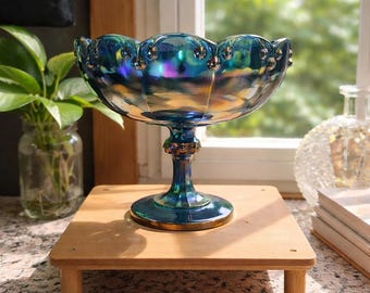 Indiana Glass Blue Iridescent Carnival Glass pedestal compote with a garland and teardrop pattern.