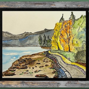 May include: Watercolour landscape painting in a rustic wooden frame. The artwork depicts a winding road along a lake, with colourful trees in the background. The painting has a serene and natural feel, with soft colours and brushstrokes.