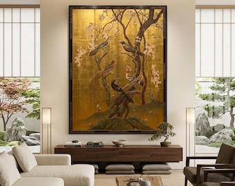 May include: A large, framed artwork with a gold background, depicting birds on tree branches with pink blossoms. The artwork is the focal point of a modern living room with neutral-toned furniture and a natural aesthetic, creating a serene atmosphere.