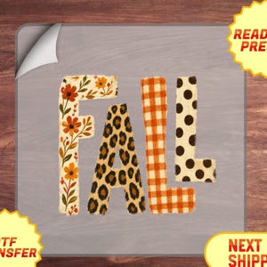 May include: A DTF transfer sheet featuring the word FALL in large block letters. The F has a floral pattern with orange and brown flowers, the A has a brown and black leopard print, the L has an orange gingham check, and the second L has black polka dots.