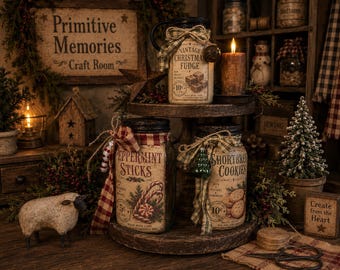 May include: A two-tiered wooden stand holding three glass jars with black lids. The jars feature labels for Vintage Christmas Fudge, Peppermint Sticks, and Shortbread Cookies, each decorated with plaid ribbons and small festive ornaments.