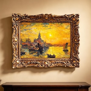 May include: A rectangular oil painting in a heavy, ornate gold-toned frame. The artwork depicts a harbor scene at sunset with a bright yellow sky, a central city skyline, and several small boats floating on the water in warm, golden hues.