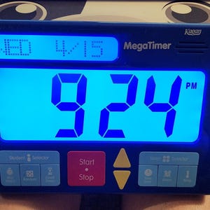May include: A blue MegaTimer digital timer displaying the time as 9:24 PM on Wednesday, April 15. The timer has buttons for student and team selection, start/stop, and other functions.