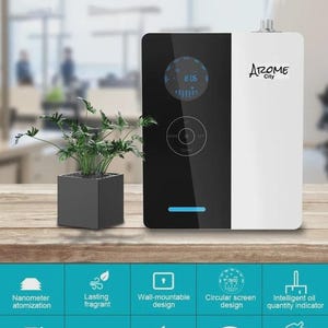 May include: A white and black aromatherapy diffuser with the text "Arome City" and a digital display. Features include a circular screen design, wall-mountable design, and intelligent oil quantity indicator. A small potted plant sits to the left of the diffuser.