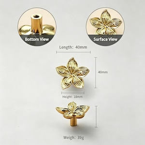May include: Gold-colored flower-shaped cabinet knobs. The knobs are 40mm long, 40mm wide, and 18mm high, with a weight of 39g. The image includes views from the bottom and surface, showcasing the detailed floral design. These decorative knobs are ideal for furniture.