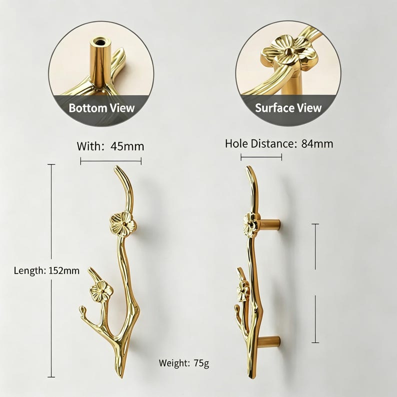 May include: Gold-colored decorative door handles with a floral branch design. The handles are 152mm long, 45mm wide, and weigh 75g. The hole distance is 84mm. The image includes bottom and surface views of the handle.