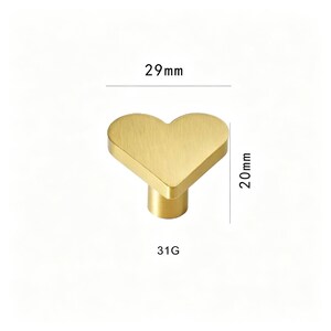 May include: A heart-shaped cabinet knob in a brushed gold finish. The knob measures 29mm wide and 20mm tall. The text "31G" is printed below the knob.