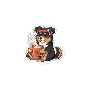 May include: A sticker illustration of a black, tan, and white dog wearing an orange headband with a white bow. The dog is sitting and holding a large, warm, orange mug with a paw print design, from which white steam swirls upward into the air.