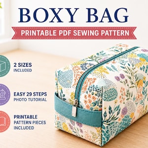 May include: A boxy bag with a floral pattern in yellow, blue, and green, featuring a teal zipper and handle. Text reads: BOXY BAG, PRINTABLE PDF SEWING PATTERN, 2 SIZES INCLUDED, EASY 29 STEPS PHOTO TUTORIAL, and PRINTABLE PATTERN PIECES INCLUDED.