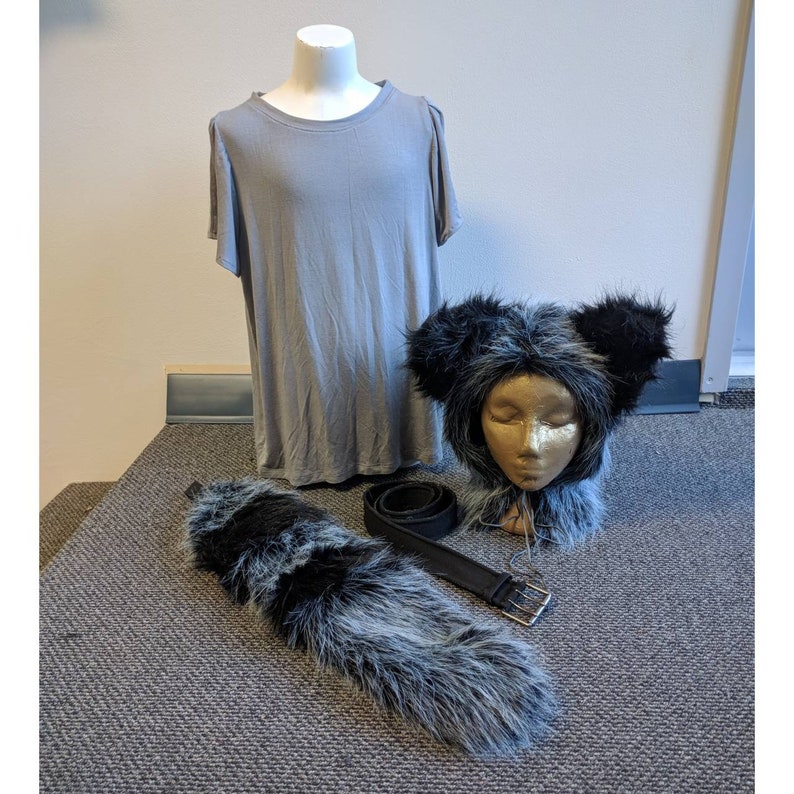 May include: A gray t-shirt, a black and gray furry tail, and a black and gray furry animal head with a black headband. The animal head has a white face with closed eyes.
