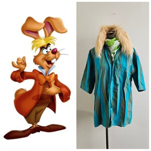 May include: A cartoon rabbit wearing a red jacket, a white shirt, a bow tie, and brown pants. The rabbit has a mischievous expression on its face. The rabbit is standing on a white background. On the right side of the image, a blue and green striped shirt with a brown fur collar is on a mannequin.