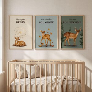 May include: Three framed art prints featuring deer illustrations and motivational quotes. The first print reads "Here you BEGIN" with a deer lying down. The second says "Into Wonder YOU GROW" with a deer and falling leaves. The third says "Fearless YOU BECOME" with a deer in a forest.