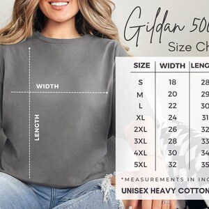 May include: A gray unisex heavy cotton tee shirt with a size chart. The size chart shows measurements in inches for sizes S to 5XL. The shirt is labeled as Gildan 5000.
