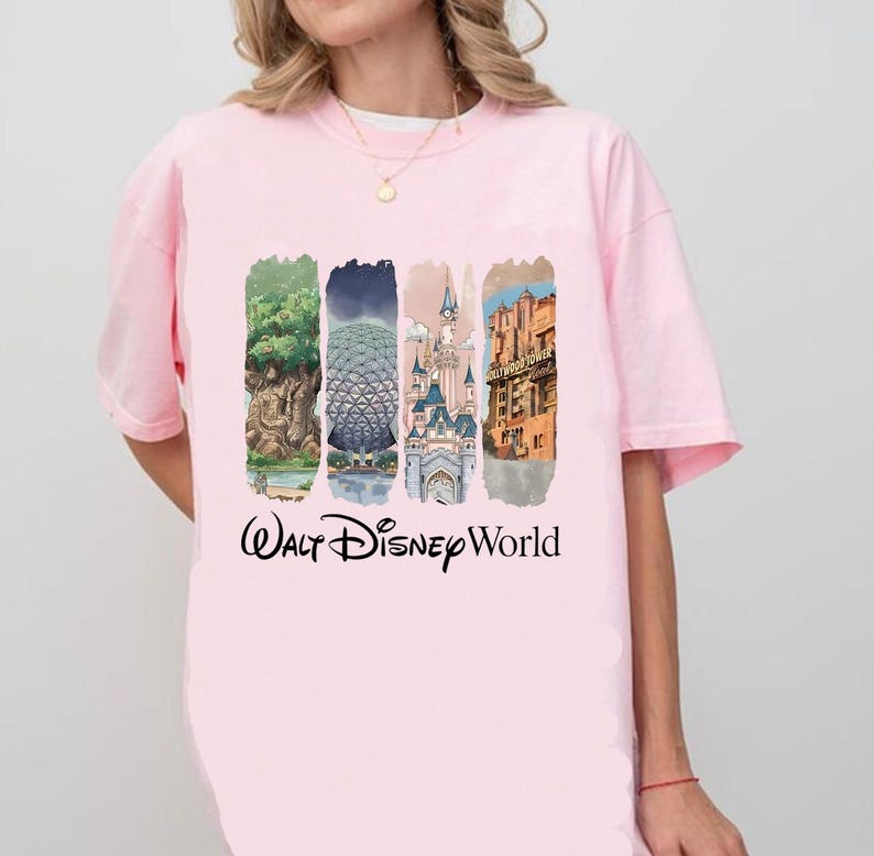 May include: Pale pink t-shirt with a graphic showcasing Walt Disney World attractions. The design includes the Tree of Life, Spaceship Earth, Cinderella Castle, and Hollywood Tower Hotel, with "Walt Disney World" written underneath.