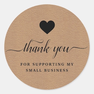 May include: Circular sticker with a textured, tan background. A black heart sits at the top, with the words "thank you" in cursive script. Beneath, it reads "FOR SUPPORTING MY SMALL BUSINESS" in a sans-serif font.