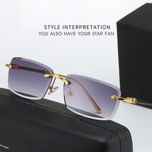 May include: Rimless sunglasses with gold-colored frames and gradient lenses. The lenses transition from a dark purple at the top to a lighter shade at the bottom. The text "STYLE INTERPRETATION YOU ALSO HAVE YOUR STAR FAN" is visible.