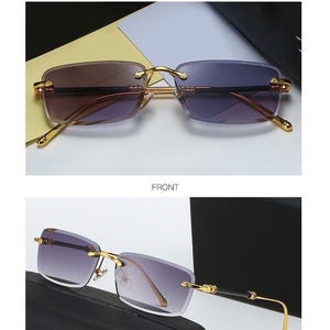 May include: Rimless sunglasses with gold-colored frames and gradient purple lenses. The product display shows the sunglasses from the front and at a 45-degree angle. The text "PRODUCT DISPLAY" and "GOLD/GRAY" are visible.