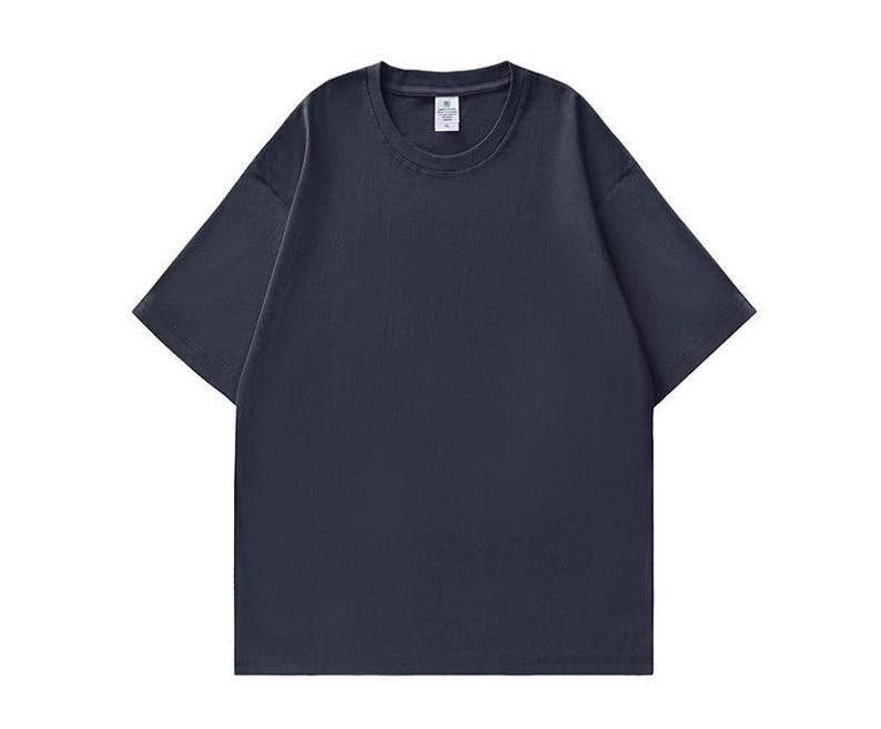 May include: A solid navy blue short-sleeve t-shirt. The shirt has a crew neck and a relaxed fit. The fabric appears to be a soft, breathable material, suitable for casual wear. The shirt is a versatile wardrobe staple.