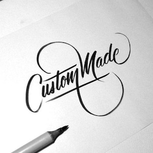 May include: Black and white image of the words "Custom Made" in elegant calligraphy. The word "Custom" is above "Made", with a line underlining the word "Made". A gray marker pen is in the lower left corner.