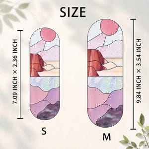 May include: Two stained glass art pieces in a landscape design. The smaller piece is 7.09 inches tall and 2.36 inches wide, while the larger is 9.84 inches tall and 3.54 inches wide. The design features a pink sun, mountains, and purple and pink hues.