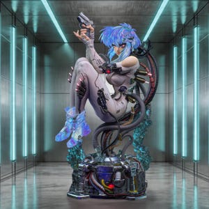 May include: A futuristic figurine of a woman with blue hair, wearing a white bodysuit and holding a silver handgun. The figure is surrounded by mechanical components and sits atop a detailed base with wires and tubes. The background features neon lights.