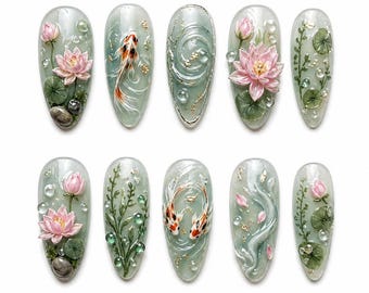 May include: A set of ten artificial nails with intricate designs. Each nail features a different aquatic theme, including koi fish, lotus flowers, water droplets, and aquatic plants, all set against a pale green background. The nails are oval-shaped and have a glossy finish.