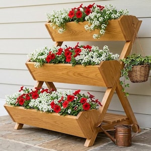 May include: A three-tiered wooden planter filled with red and white flowers. The planter has a natural wood finish and is set on a stone patio. A small copper watering can sits at the base.