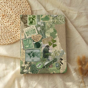 May include: A rectangular notebook cover featuring a green-toned collage of vintage-style elements, including postage stamps, a world map, a Sprite logo, a black car, botanical illustrations, and text snippets like "FORGIVE MY NORTHERN ATTITUDE."
