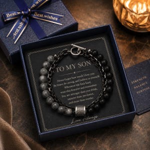 May include: A multi-strand bracelet featuring grey marbled beads, matte black beads, and a dark metal chain with a toggle clasp. The bracelet is presented in a dark blue gift box with a card inscribed with the text TO MY SON and a message.