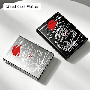May include: Two rectangular metal card wallets, one in black and one in silver, each featuring a graphic print of a car silhouette, a red sun, and white motion lines. The text Metal Card Wallet is displayed in the upper left corner of the image.