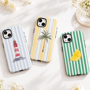 May include: Three smartphone cases featuring vertical stripes. The first case has light blue stripes and a red and white lighthouse. The second case has yellow and white stripes with a palm tree. The third case has green and white stripes with a lemon slice.