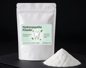 May include: A white stand-up pouch containing Hydroxyapatite Powder with a light green label featuring a tooth icon, chemical formula Ca5(PO4)3OH, 99.9% purity, 200nm particle size, and 100g net weight. A small pile of white powder sits in front.