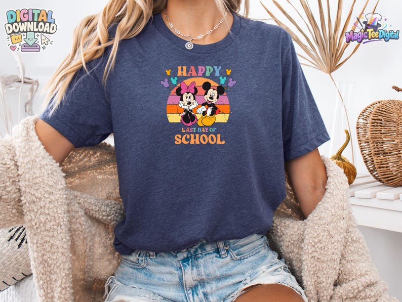 May include: A navy blue short-sleeve t-shirt featuring a graphic of Mickey and Minnie Mouse sitting in front of a retro-style orange and yellow sunset. The text "HAPPY LAST DAY OF SCHOOL" is printed in orange, with small colorful Mickey head icons.
