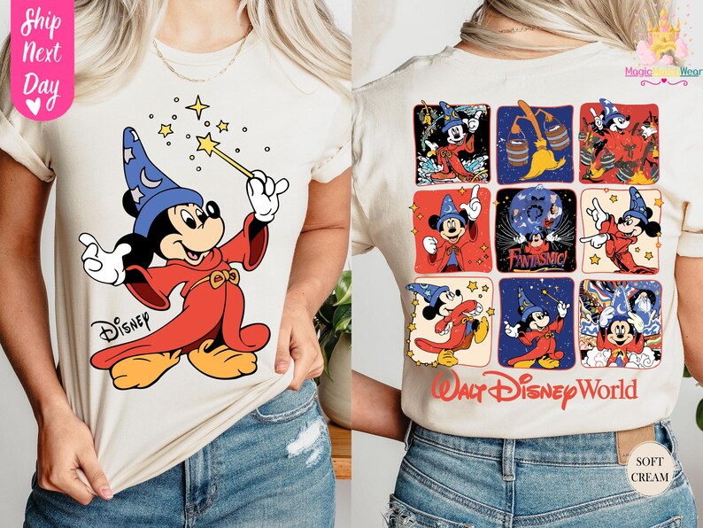 May include: Cream-colored t-shirt featuring a graphic of Mickey Mouse as a sorcerer, holding a wand with stars. The back of the shirt displays Mickey in various poses, with "Walt Disney World" text. The shirt is made of soft cream-colored material.