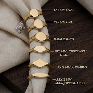 May include: Several gold signet rings are displayed, showcasing different shapes like oval, round, and rhombus. Sizes are indicated in mm, such as 6x8 mm oval and 7x12 mm rhombus. The rings are presented on a white cloth. Text reads "EST. 2024 | HANDCRAFTED JEWELRY".