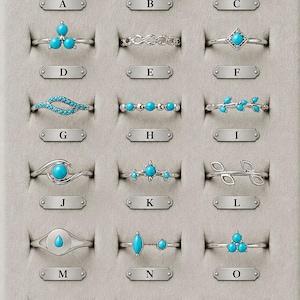 May include: A collection of eighteen silver-toned rings arranged in a grid, each labeled with a letter from A to R. The rings feature various designs, including turquoise-colored stones, leaf motifs, geometric shapes, and twisted metal bands.