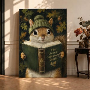 May include: A wall art print featuring a brown squirrel wearing a green knit pom-pom hat, holding an open green book titled The Acorn Collector's Guide. The background displays dark green oak leaves and acorns in a detailed, painterly style.
