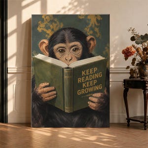 May include: A rectangular wall art print featuring a chimpanzee with dark fur holding an open green book. The book cover displays the gold text KEEP READING KEEP GROWING. The background is a dark teal with a subtle gold floral pattern.