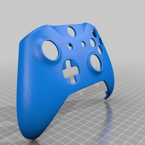 May include: A vibrant blue controller shell featuring button and joystick cutouts. The shell has a cross-shaped button and several circular and oval openings. The design is smooth and appears to be made of plastic.