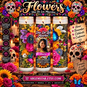 May include: Three cylindrical glass candles featuring vibrant floral patterns, butterfly motifs, and sugar skull imagery. The center candle displays a photograph of a person, the name Maria, and Spanish text. The design includes colorful marigolds.