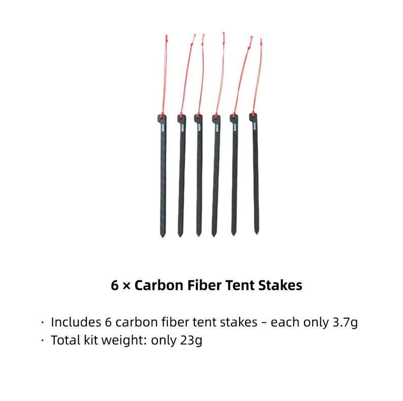 May include: Six black carbon fiber tent stakes, each featuring a thin red pull cord attached to the top. The text 6 x Carbon Fiber Tent Stakes is displayed below, noting each stake weighs 3.7g and the total kit weight is 23g.