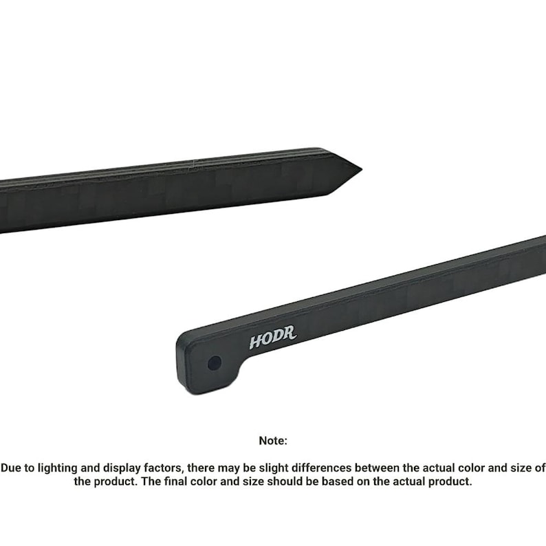 May include: Two black, elongated, rectangular components with a carbon fiber-like texture. One piece features a pointed end, while the other has a rounded end with a circular hole and the white text HODR printed on its side surface.