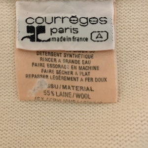 May include: White tag with black text that reads "courr&egrave;ges paris made in france" and a letter "A" in a circle. The tag also includes care instructions in French and the material composition: "55% LAINE/WOOL".