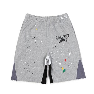 May include: Grey sweat shorts with a paint splatter design and the text "GALLERY DEPT." in black. The shorts have a drawstring waistband, black and white accents, and grey side panels.
