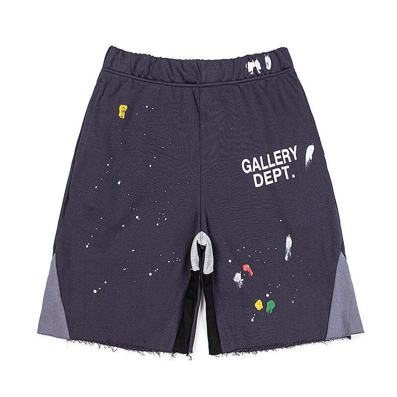 May include: Dark grey athletic shorts with paint splatter details. The shorts feature the text "GALLERY DEPT." in white. The shorts have grey and black accents on the sides and bottom.