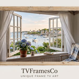 May include: A rectangular wooden frame containing a digital display of an open window view overlooking a coastal harbor with sailboats, a lighthouse, and a village. A potted blue hydrangea, a mug, and a book sit on the window sill. Text reads TVFramesCo.