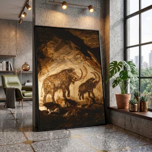 May include: Framed artwork depicting cave paintings of two woolly mammoths in shades of brown and tan. The artwork is displayed in a modern interior setting with a window and plants.